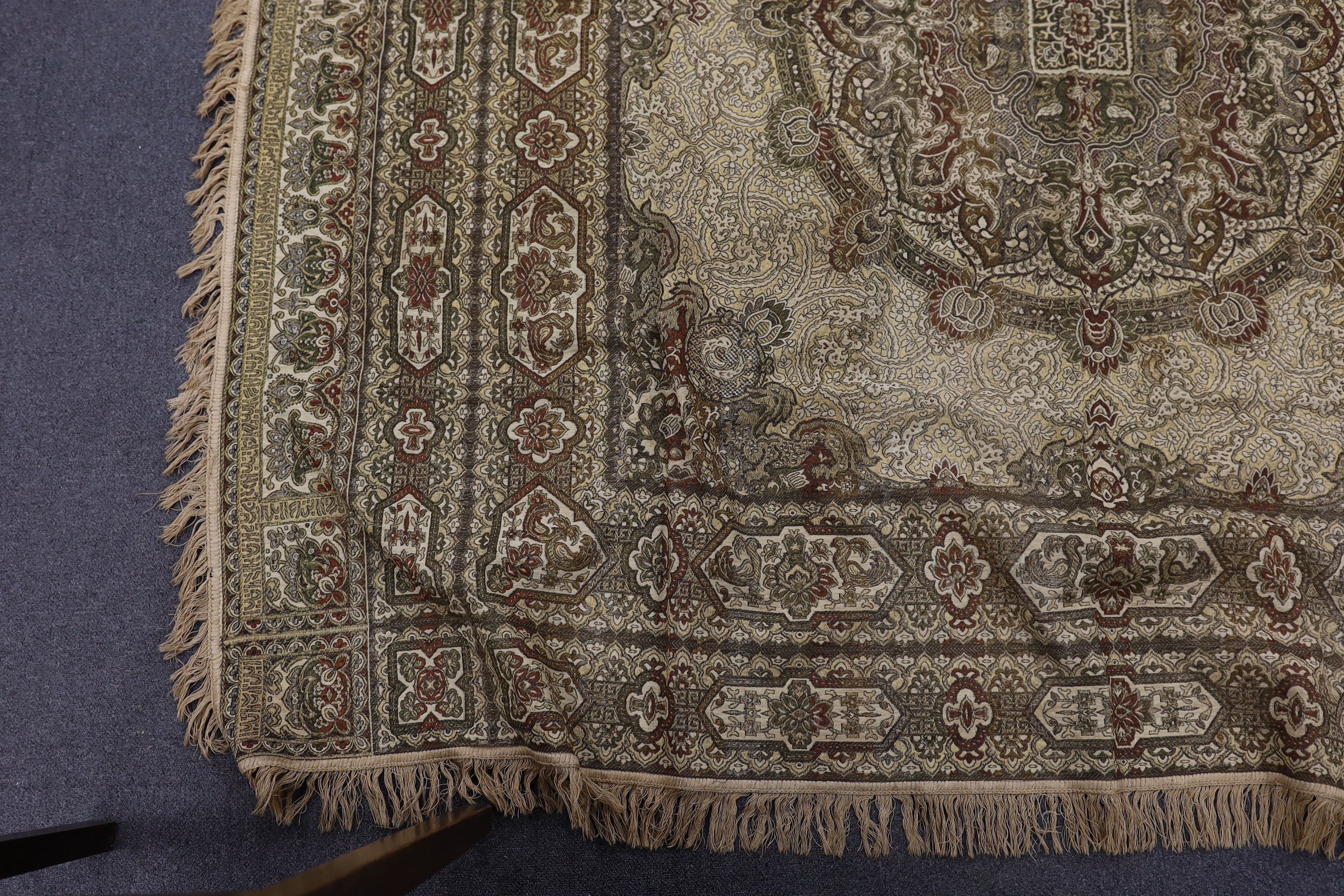 Two 19th century Indian heavy metallic thread embroideries on silk, another smaller similar panel and later 20th century machine woven fringed bedcover, two metal embroideries 53cm x 52cm